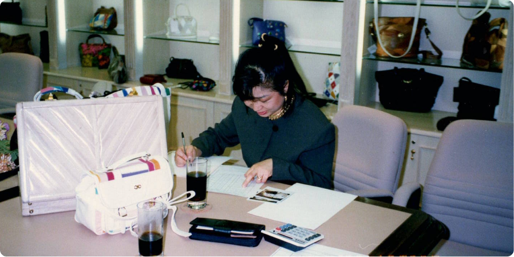 Judy Kwon conducts business while sitting at a desk