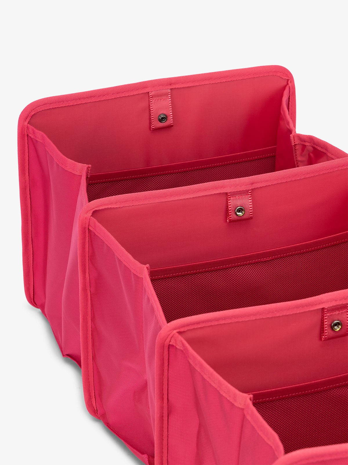CALPAK collapsible car trunk organizer featuring compartments in pink dragonfruit