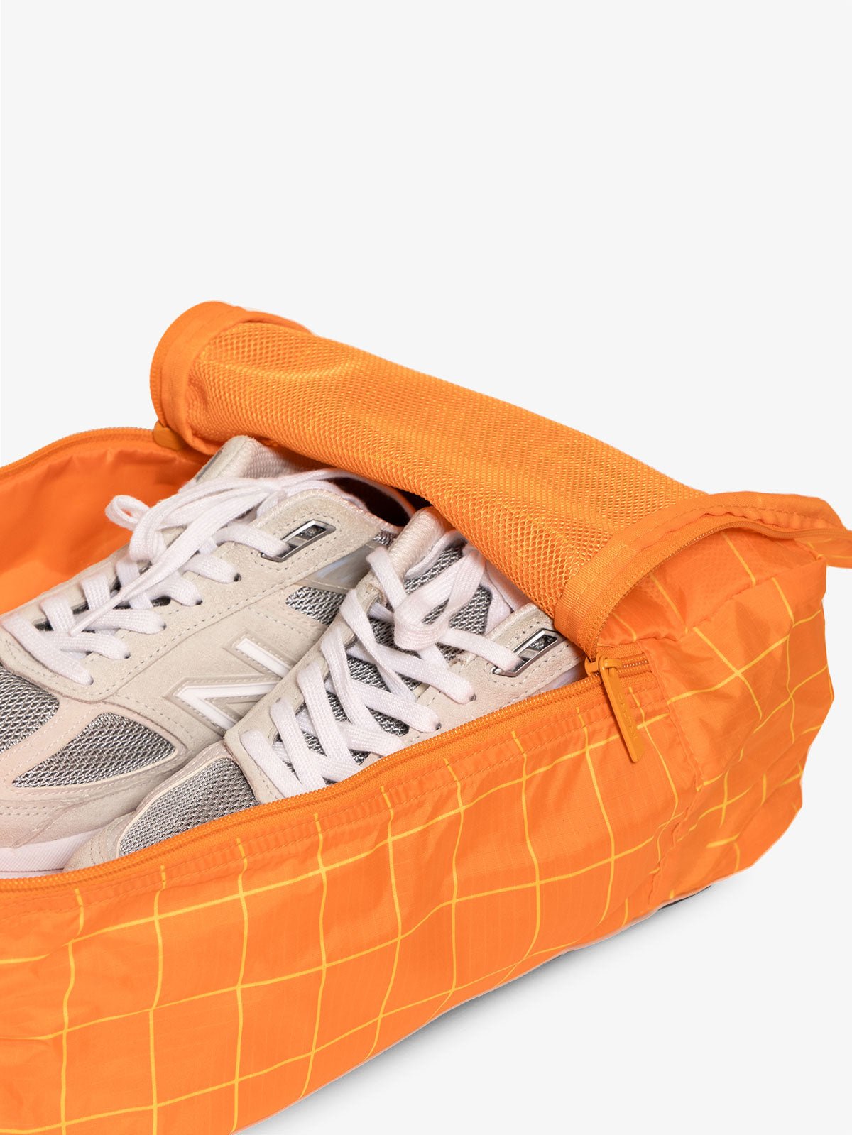 CALPAK Compakt zippered shoe travel bag with mesh pocket in orange grid