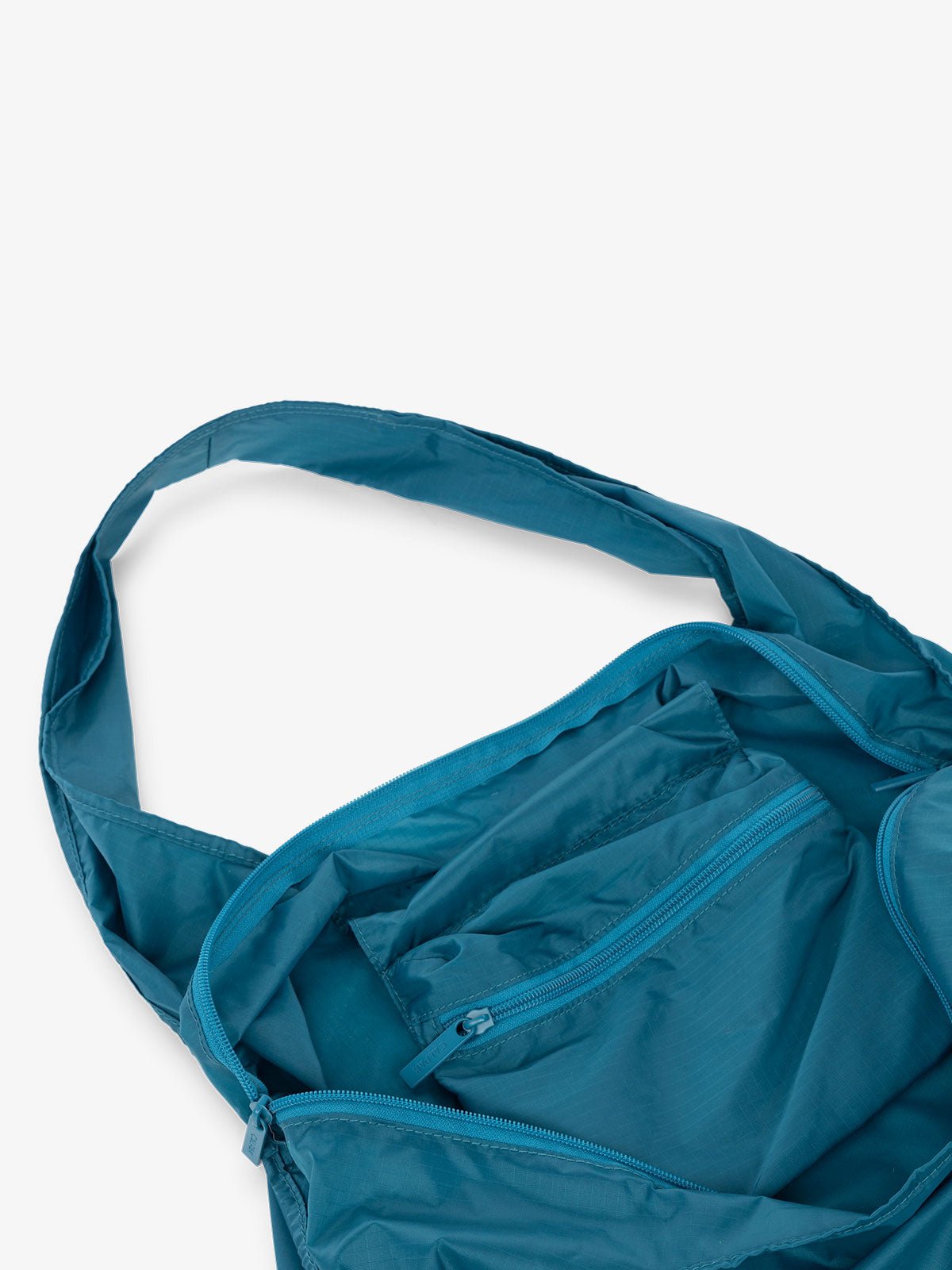 CALPAK Compakt shopping tote bag with interior zipper pocket in lagoon blue