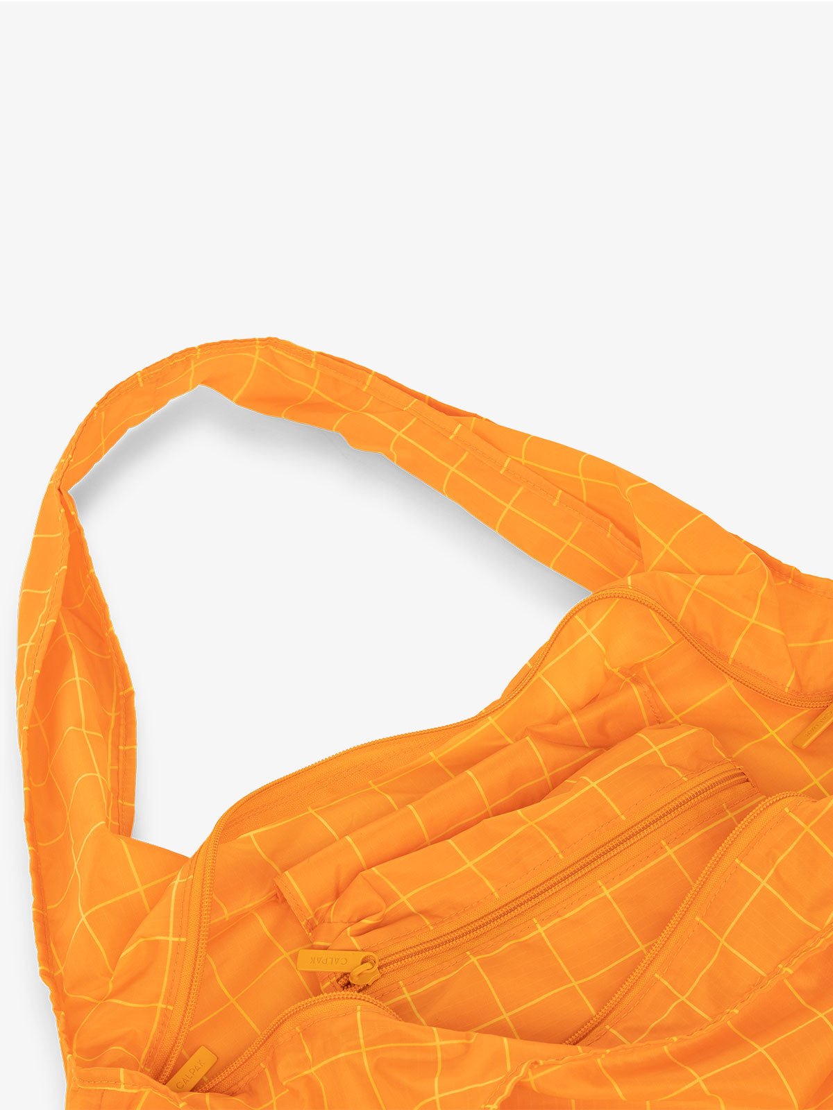 CALPAK Compakt shopping tote bag with interior zipper pocket in orange grid print