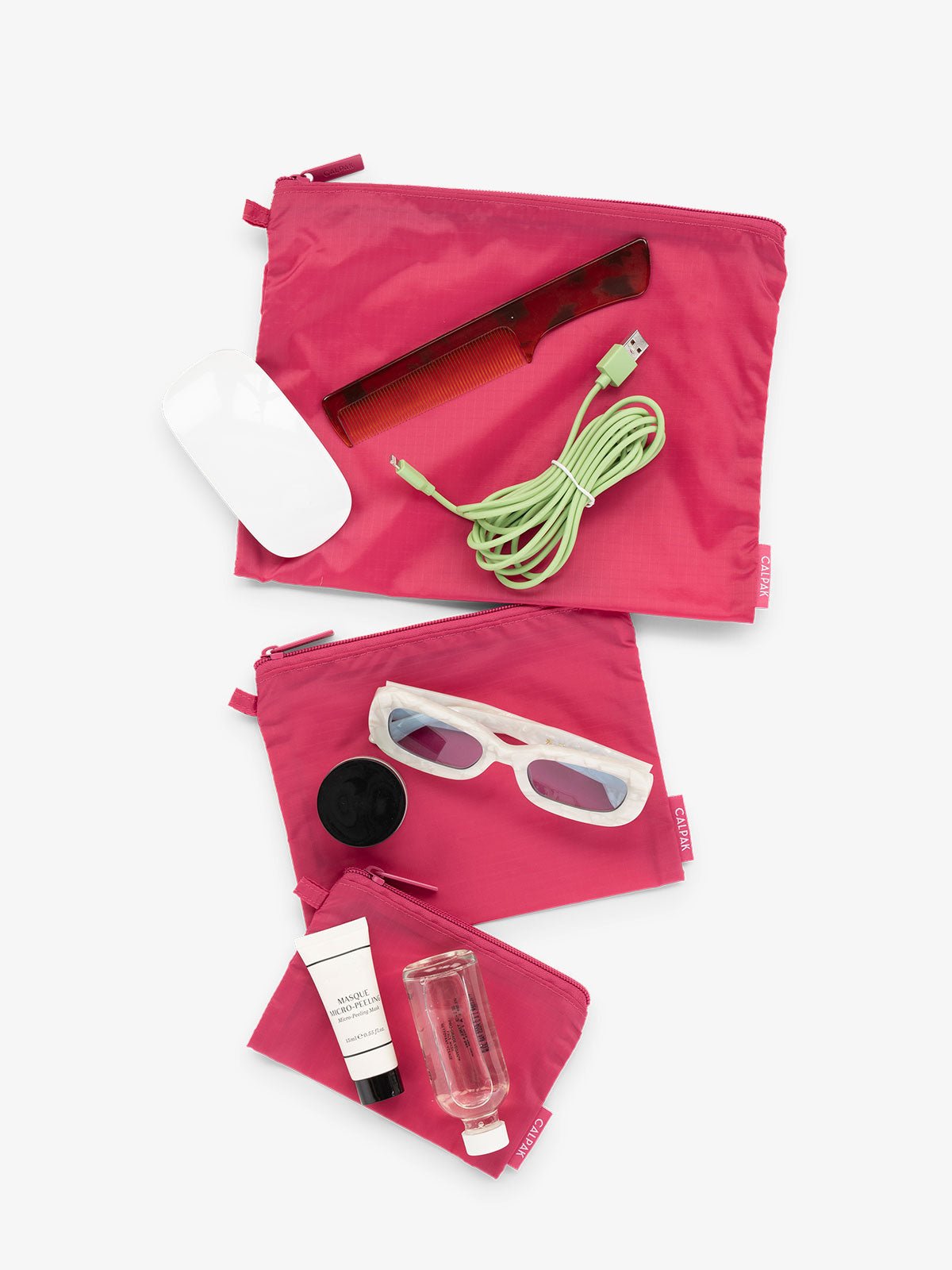 CALPAK Compakt 3 piece zippered pouch set in 3 sizes with water resistant material in dragonfruit pink
