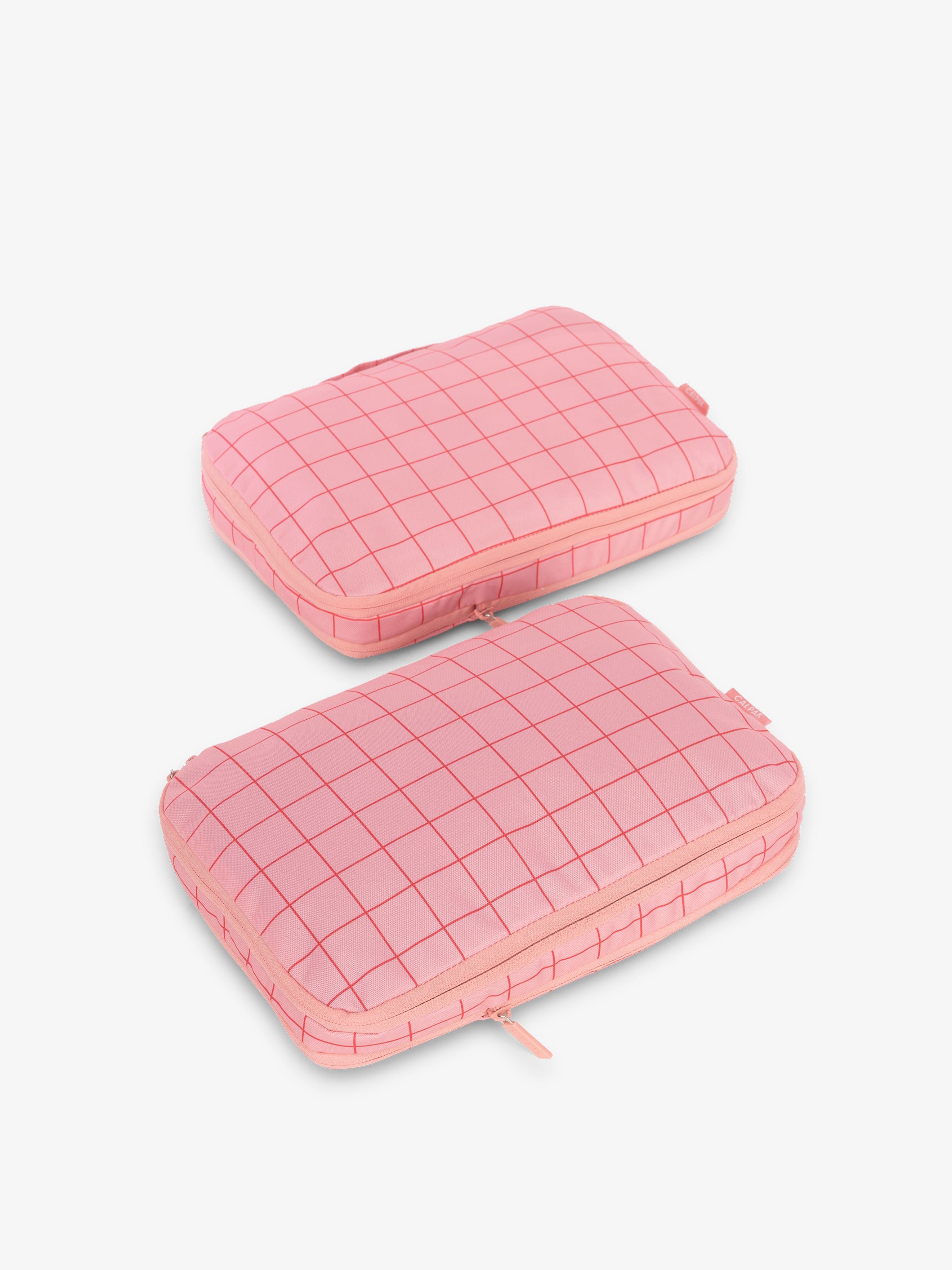 CALPAK compression packing cubes in pink grid