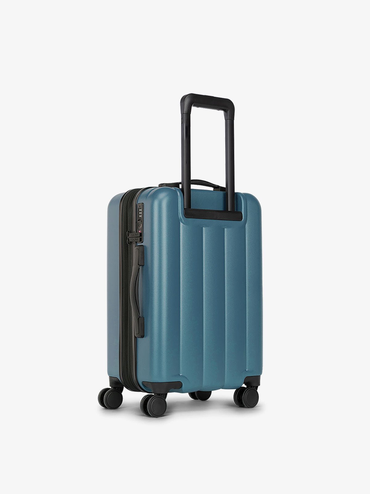 CALPAK carry-on luggage featuring dual spinner wheels and bottom grab handle in pacific