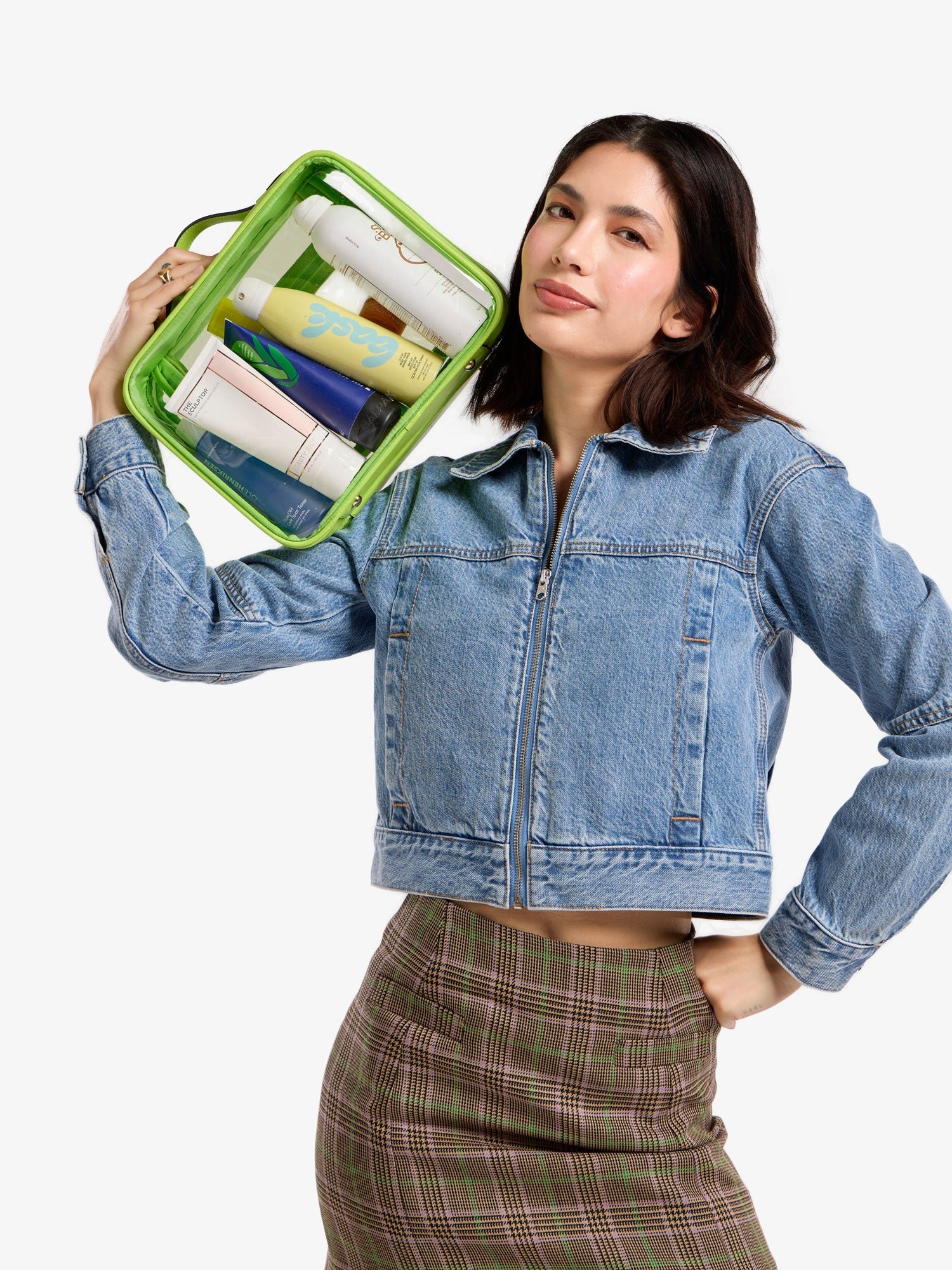 Model resting large clear cosmetic case on shoulder in lime green