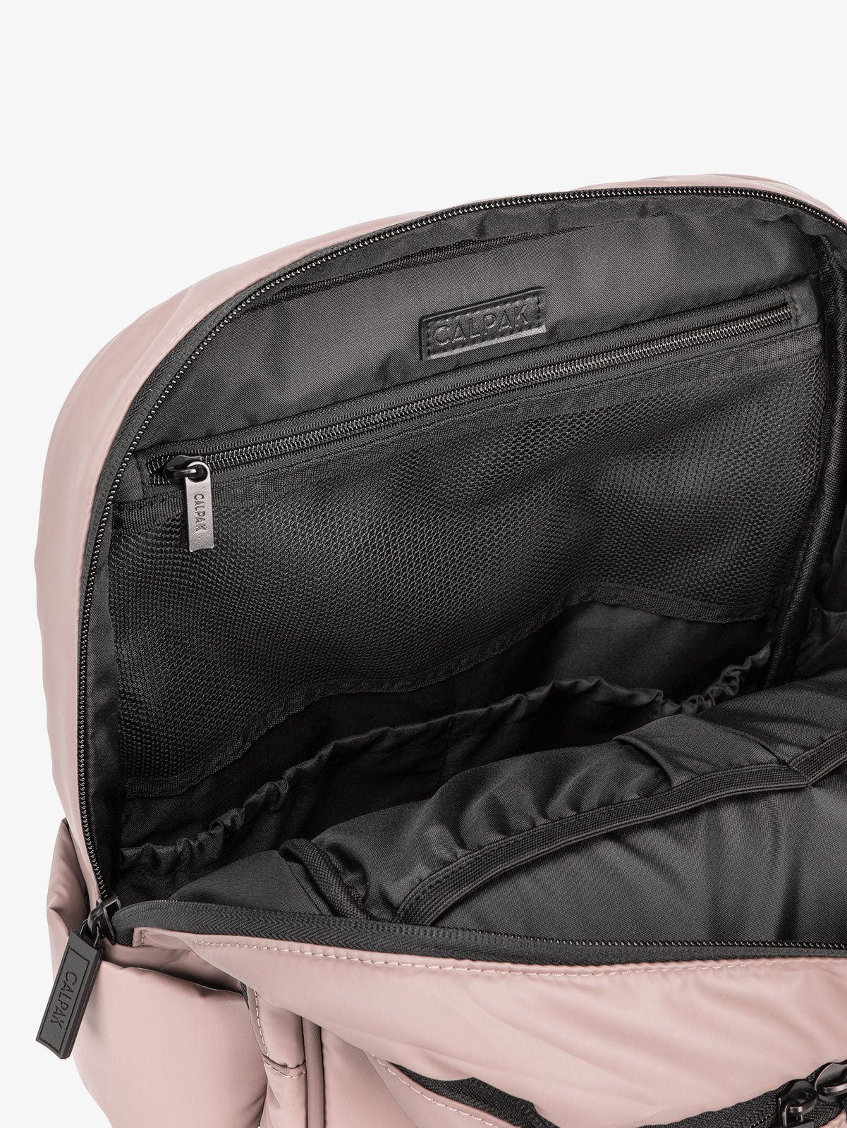 Close up of main compartment of CALPAK laptop backpack with multiple interior pockets in pink rose quartz