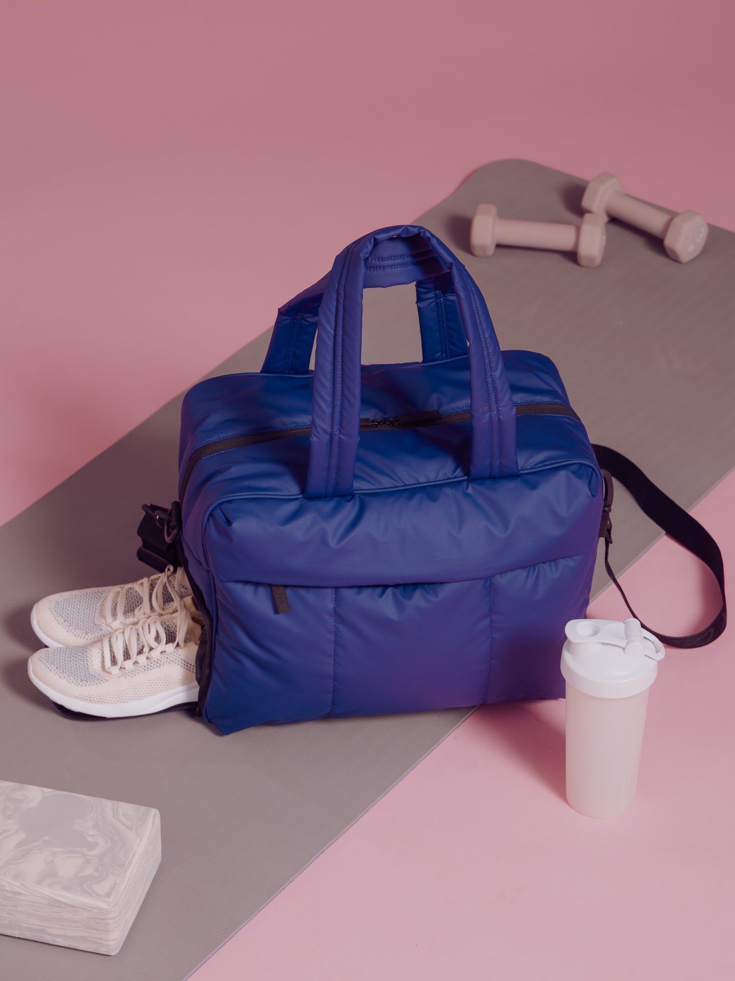 Navy blue CALPAK Luka Duffel featuring side shoe compartment for gym
