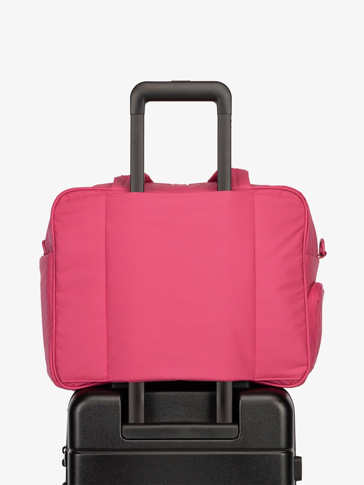CALPAK Luka Duffel bag with luggage trolley sleeve in hot pink dragonfruit