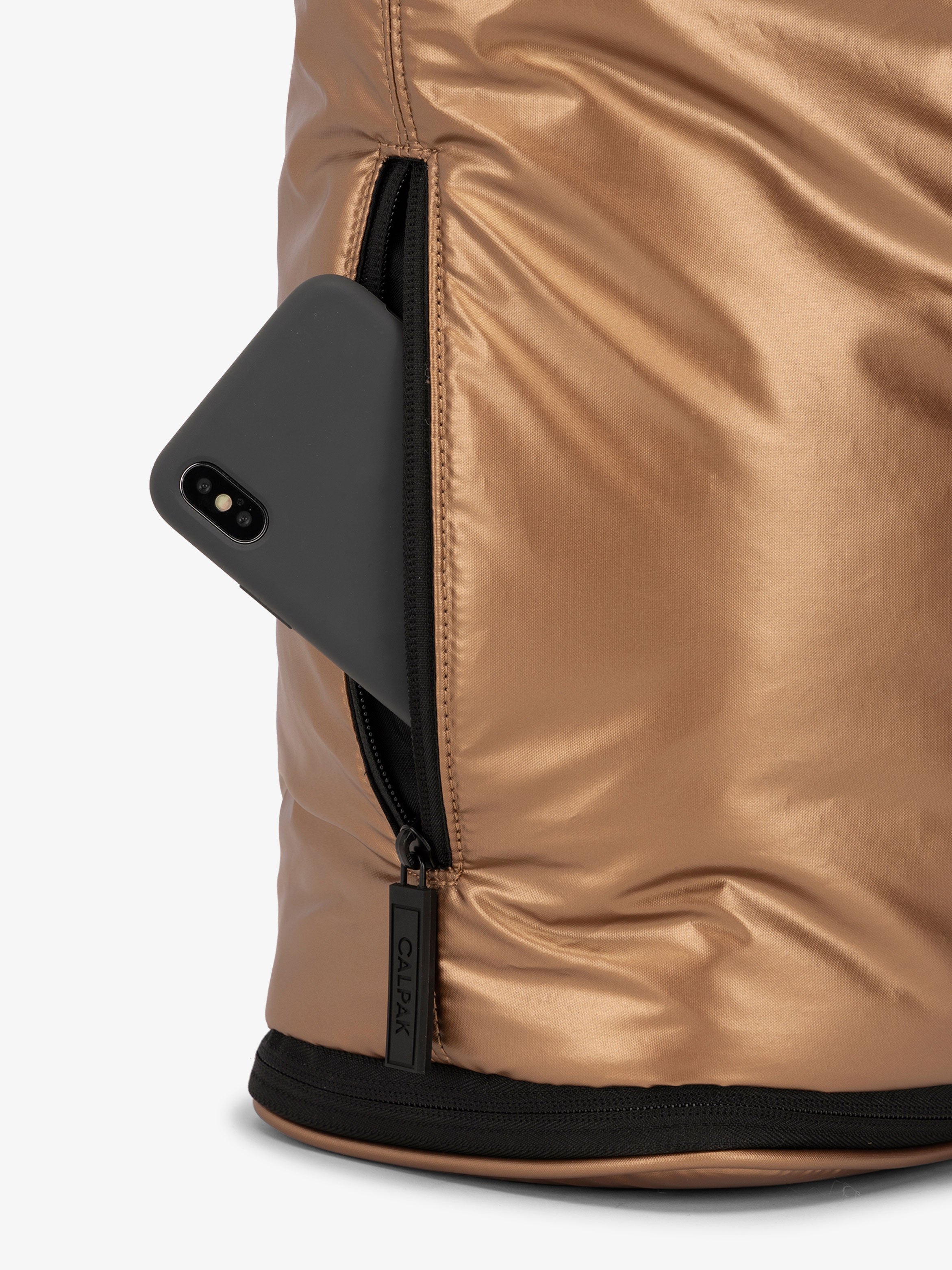 CALPAK Luka expandable laptop bag with hidden zippered pockets in metallic copper