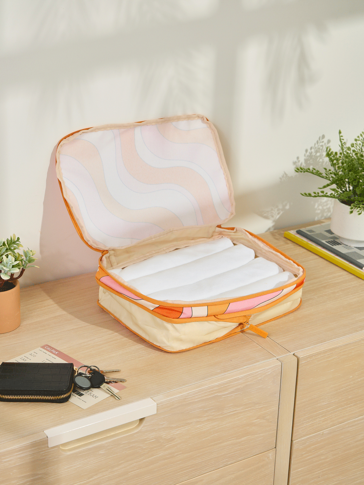 CALPAK Medium Compression Packing Cubes made of durable material and expandable by 4.5" in retro sunset