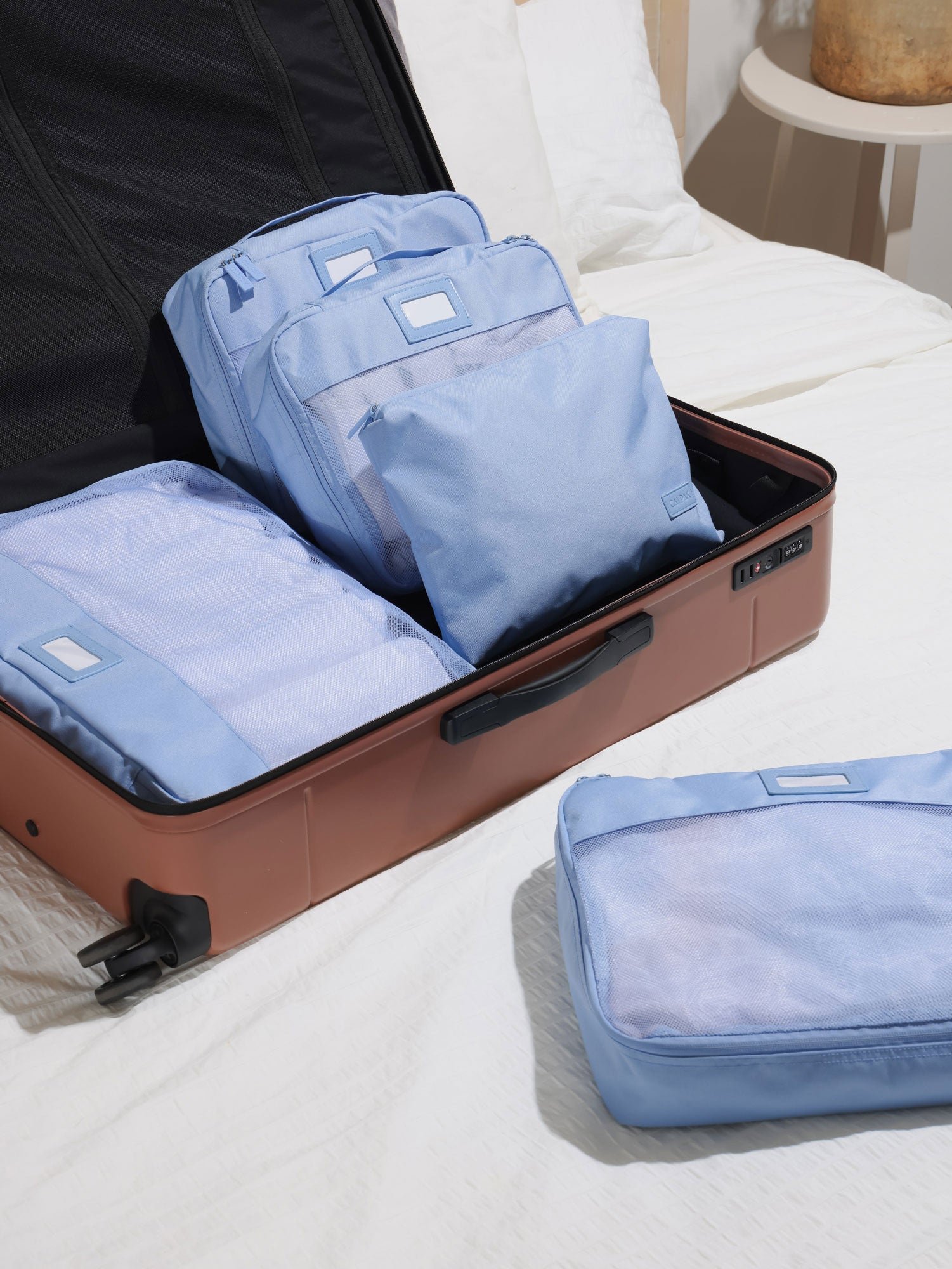 CALPAK 5 piece set packing cubes for travel with labels and top handles mesh front in sky blue