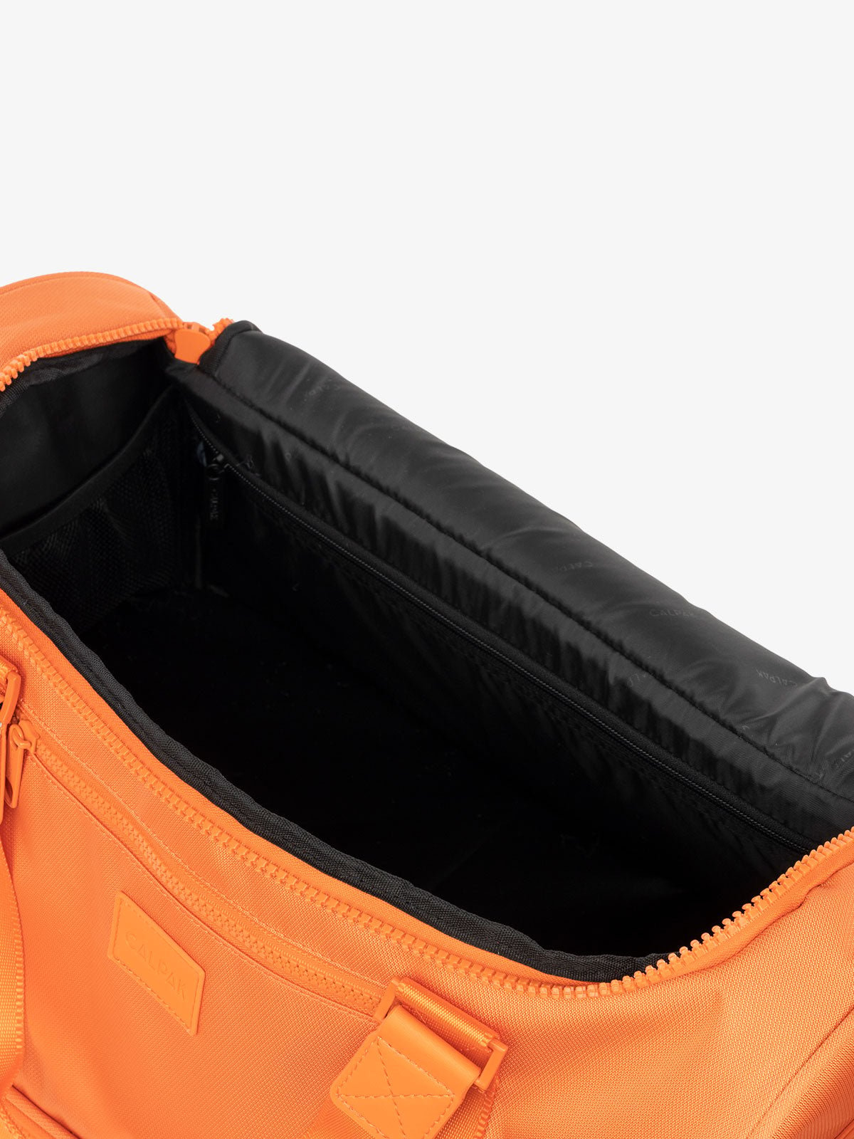 CALPAK Stevyn Duffel with multiple interior pockets in orange