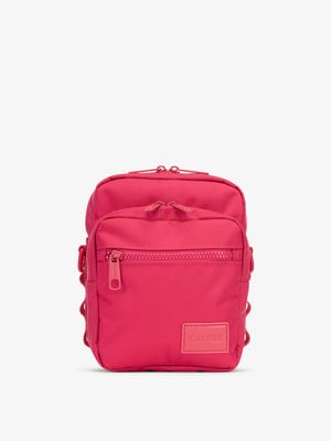 Front-view of CALPAK Stevyn Mini Crossbody Bag with zippered pockets and side panel daisy chains in pink dragonfruit; ACS2301-DRAGONFRUIT