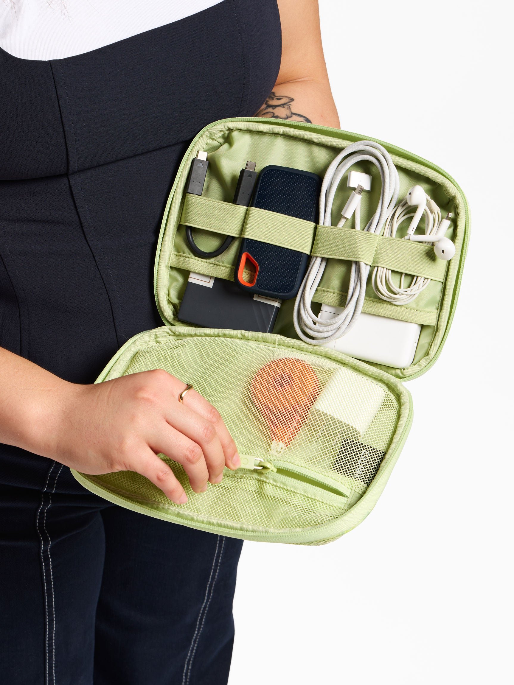 Model displaying cords and electronics organized within lime viper tech organizer