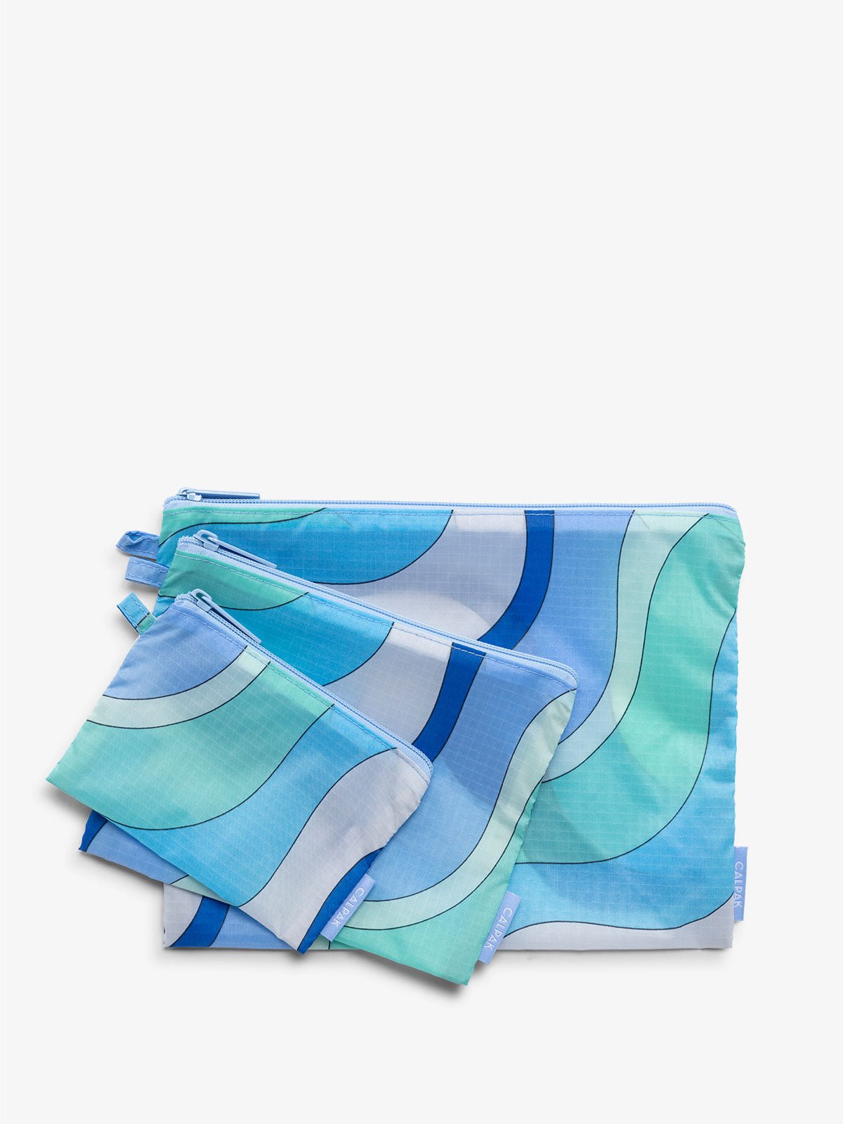 set of storage pouches for luggage travel in wavy blue pattern
