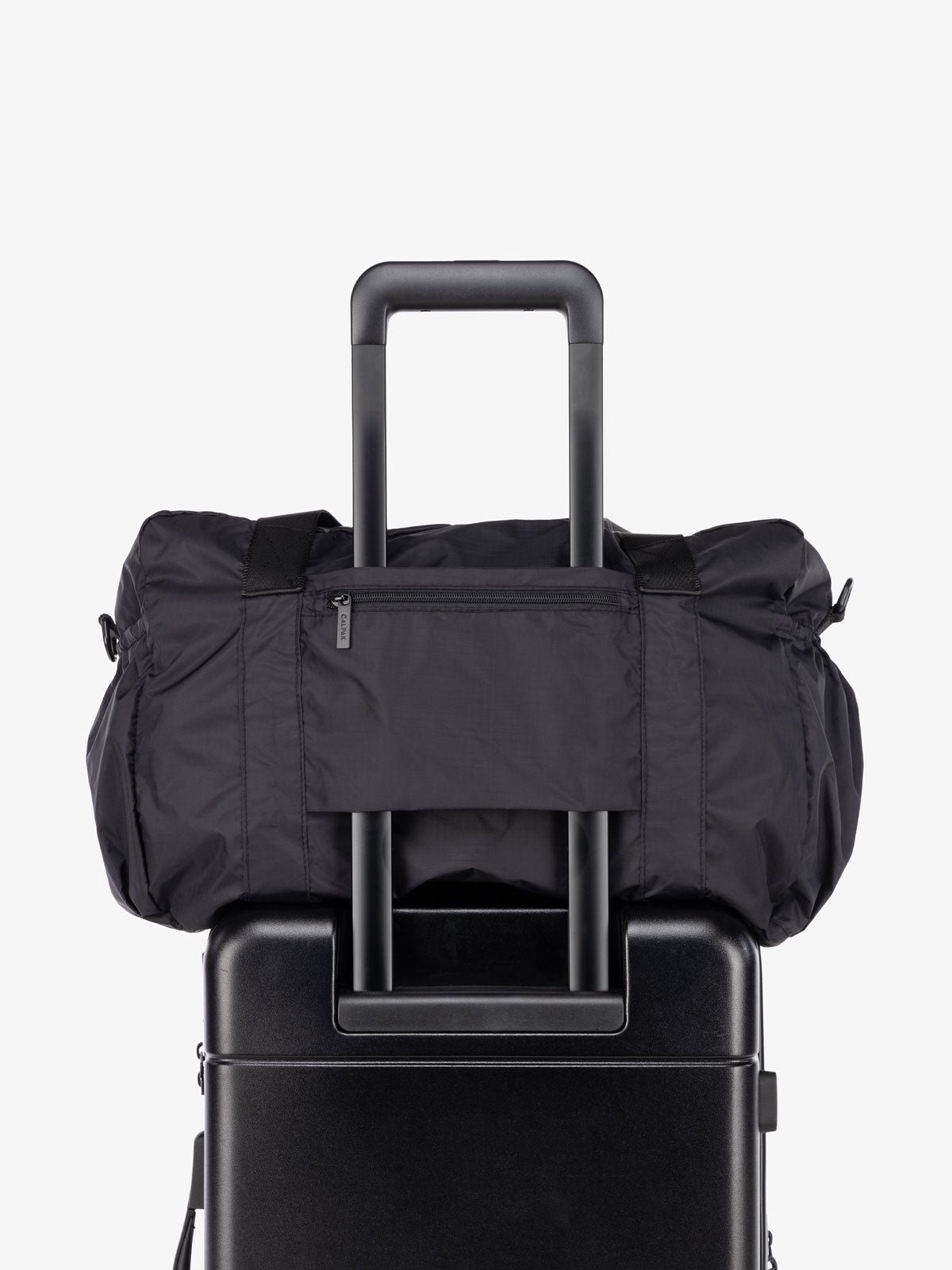 CALPAK black nylon duffle bag with pockets for travel