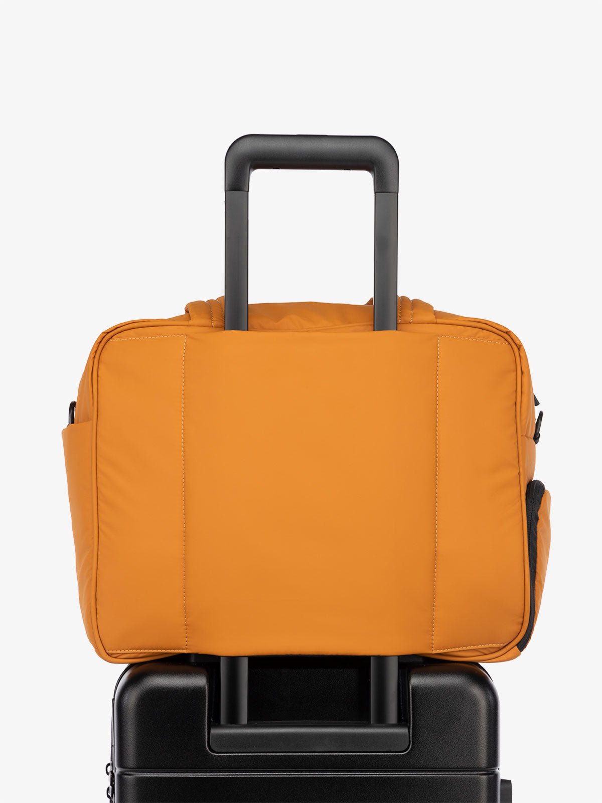 CALPAK Luka Duffle Bag luggage sleeve in pumpkin