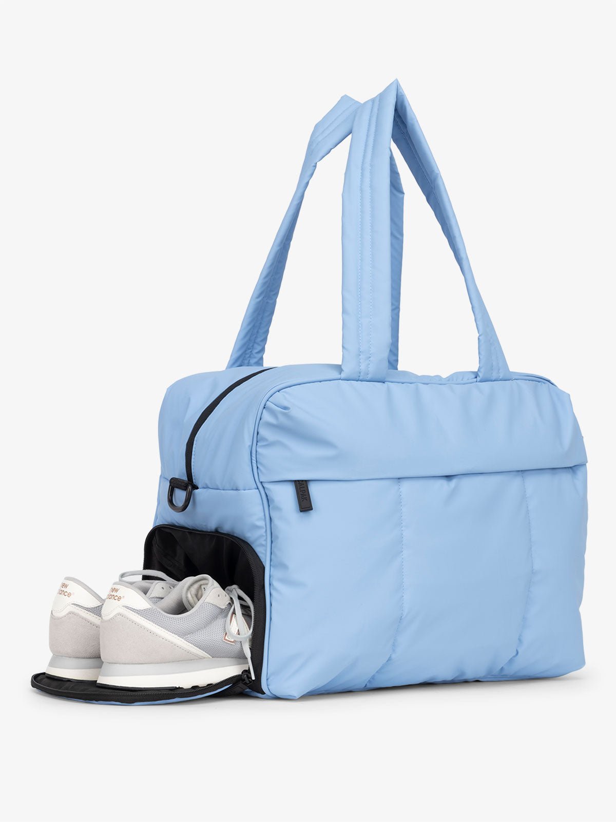 CALPAK Luka Duffel Bag with side shoe compartment and top handles in light blue