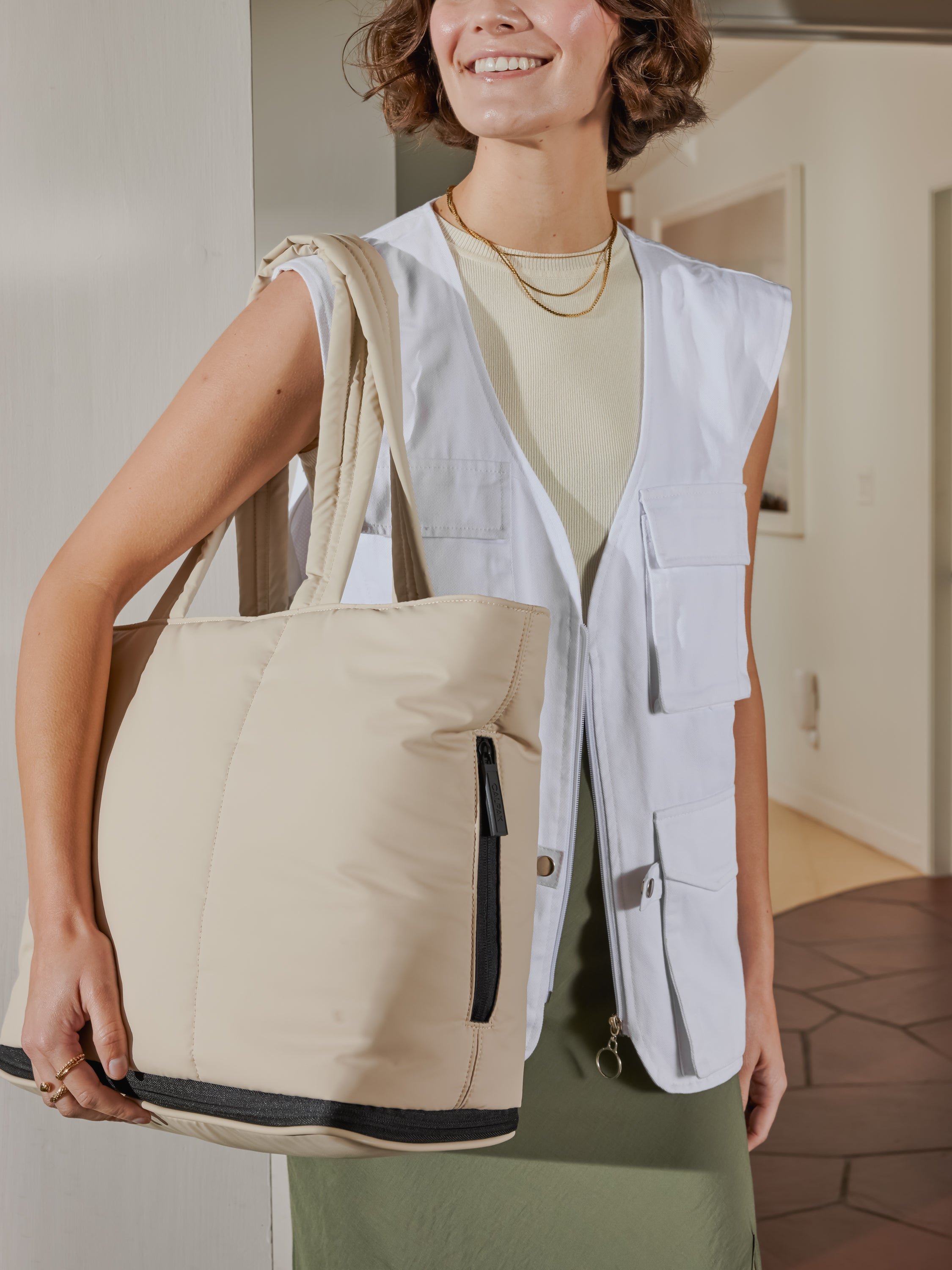 CALPAK Luka expandable bag with zippered pockets and laptop compartment in ivory