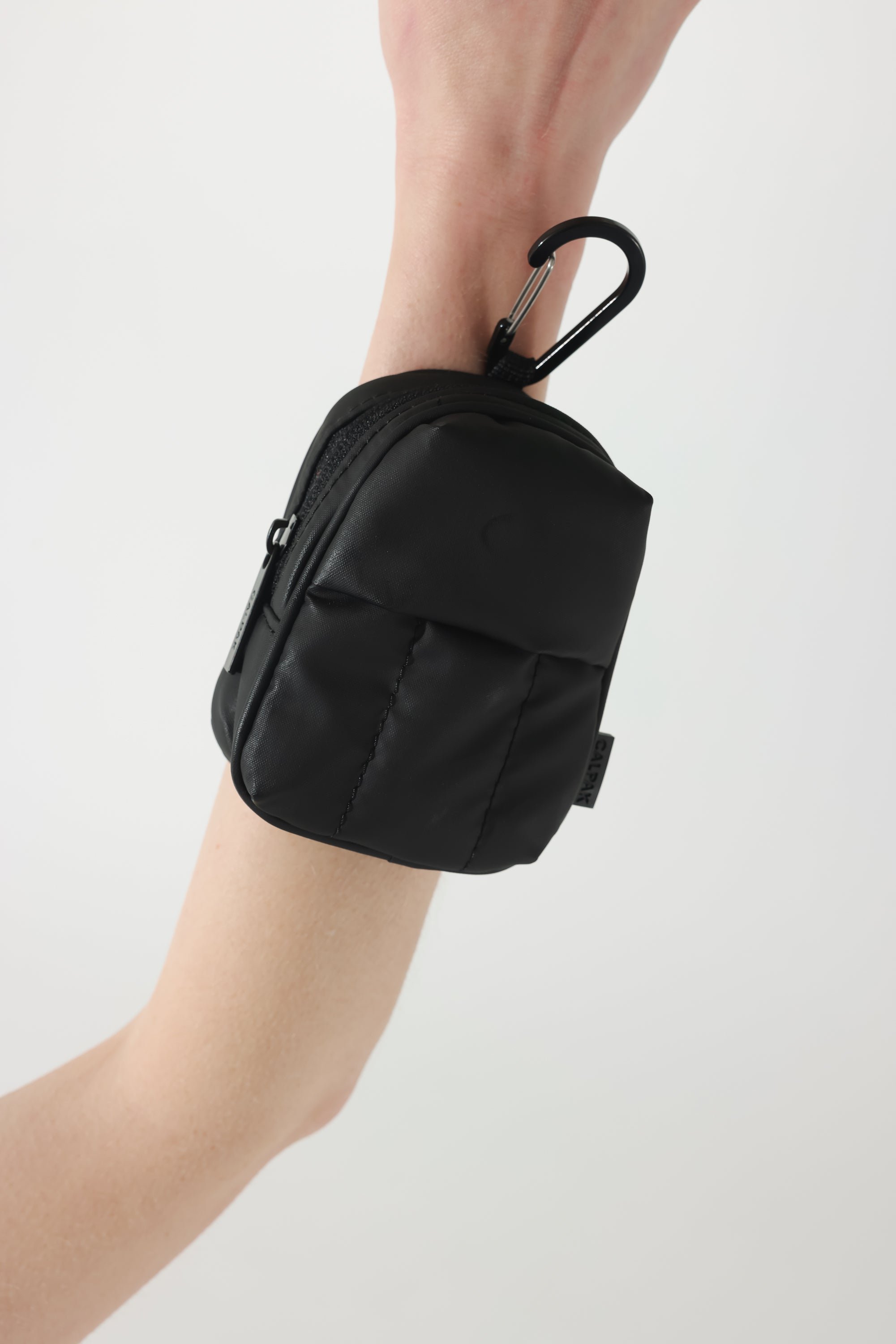 CALPAK Luka backpack key chain with back versatile elastic wrist strap and carabiner clip in matte black