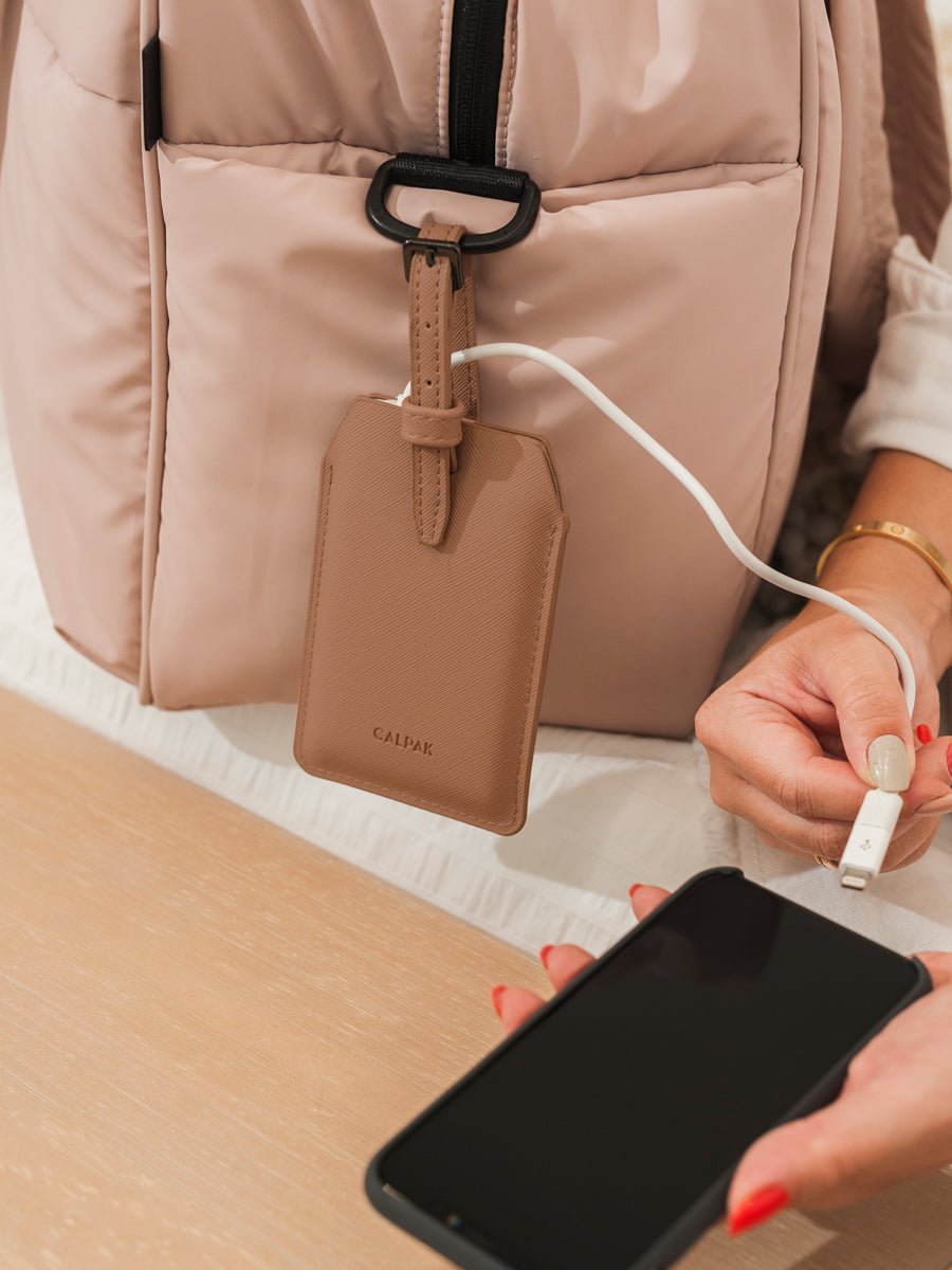 CALPAK portable charger and luggage tag in caramel color
