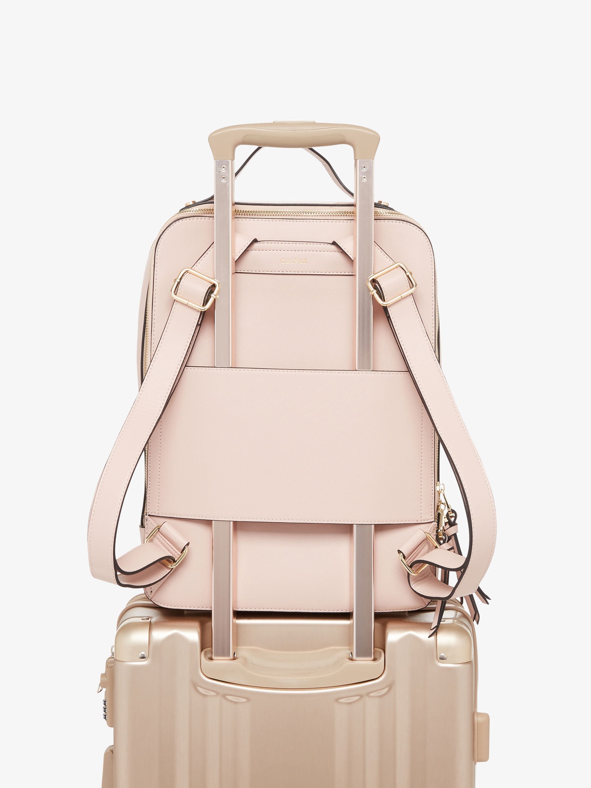 pink blush CALPAK Kaya laptop backpack with luggage trolley sleeve