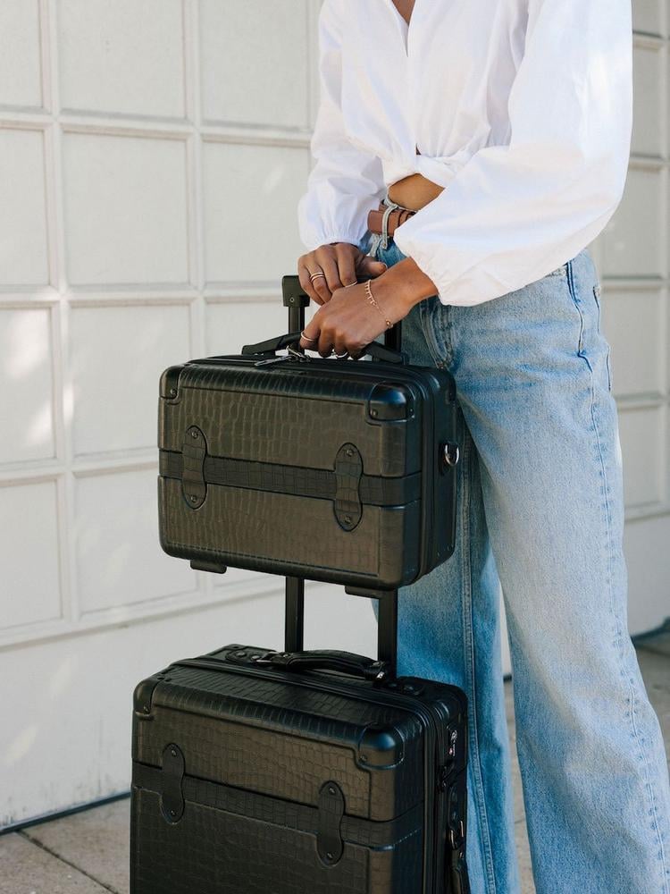 CALPAK TRNK black vanity case and TRNK carry on suitcase modelled