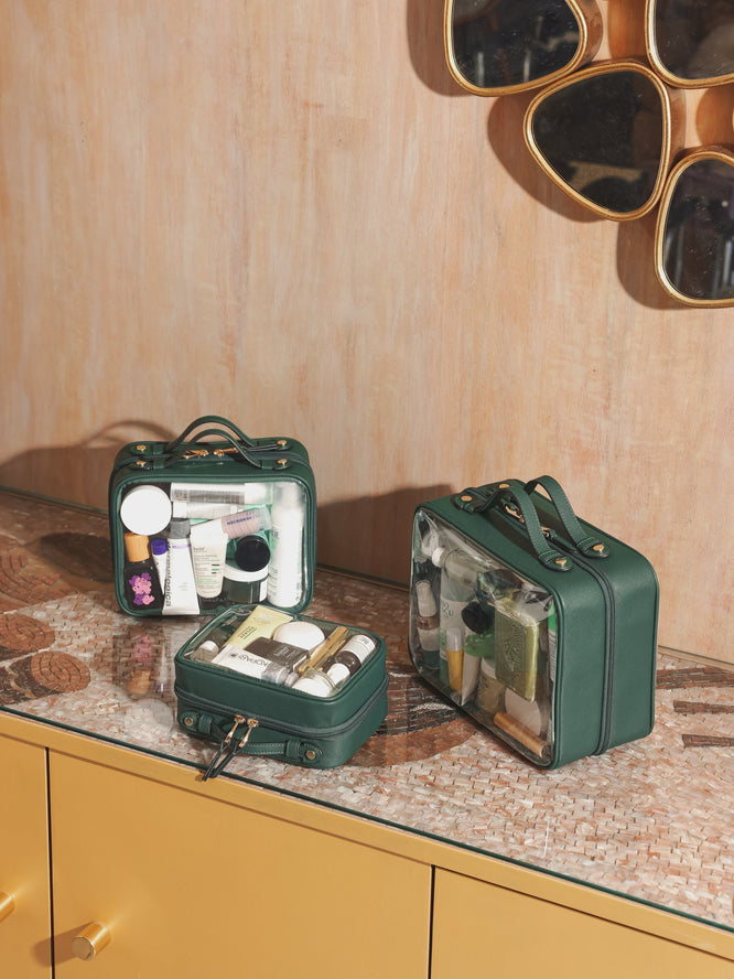 CALPAK Cosmetics cases in small, medium and large in green packed with skincare and makeup for travel