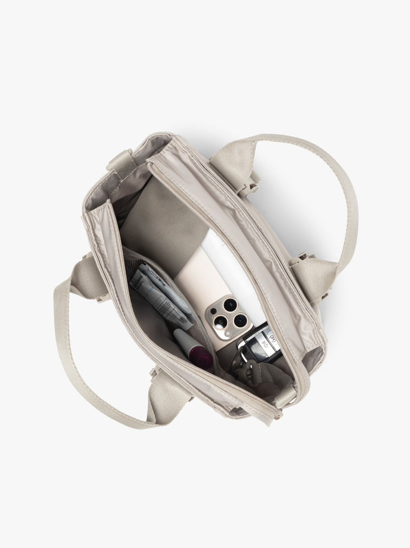 Inside of CALPAK Fit Gym Crossbody Bag in beige Greige with white background