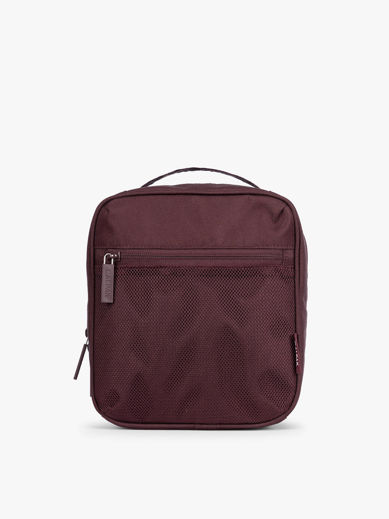 Dark burgundy Dark Cherry color of the CALPAK Everything Cube organizer with a top handle, a front zippered pocket, and a textured mesh lower panel, shown against a plain white background