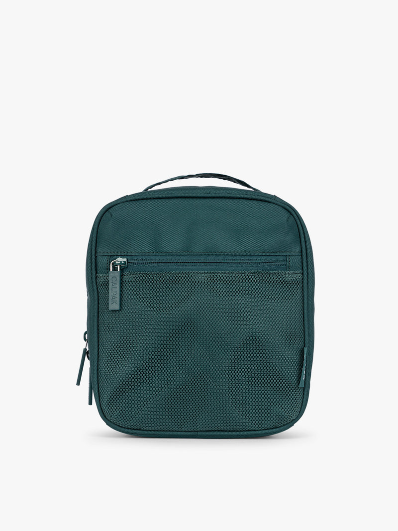 A dark teal green Kale CALPAK Everything Cube organizer with a top handle, a front zippered pocket, and a textured mesh lower panel, shown against a plain white background