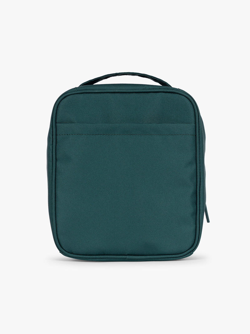 Back side of a dark teal green Kale CALPAK Everything Cube organizer with a top handle, a front zippered pocket, and a textured mesh lower panel, shown against a plain white background