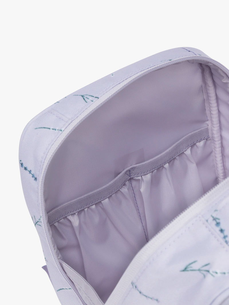 Inside pockets of CALPAK Everything Cube in light purple with lavender flower print