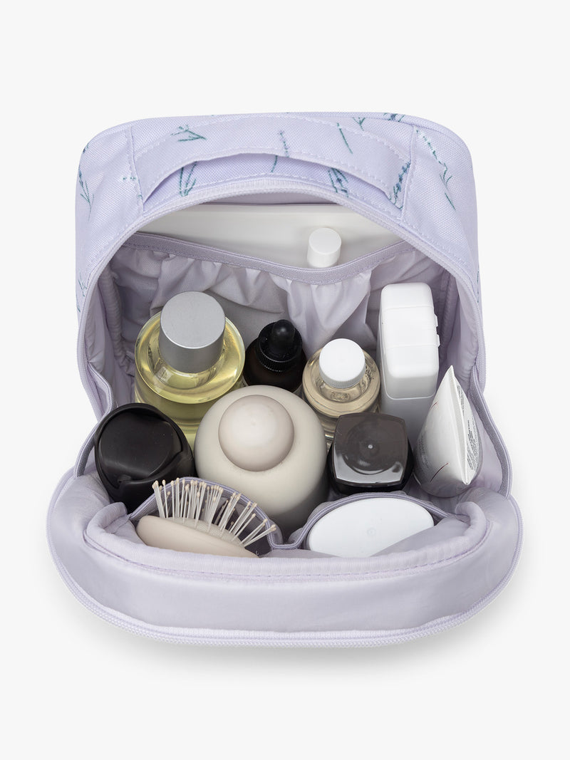 Products inside the CALPAK Everything Cube in light purple with lavender flower print