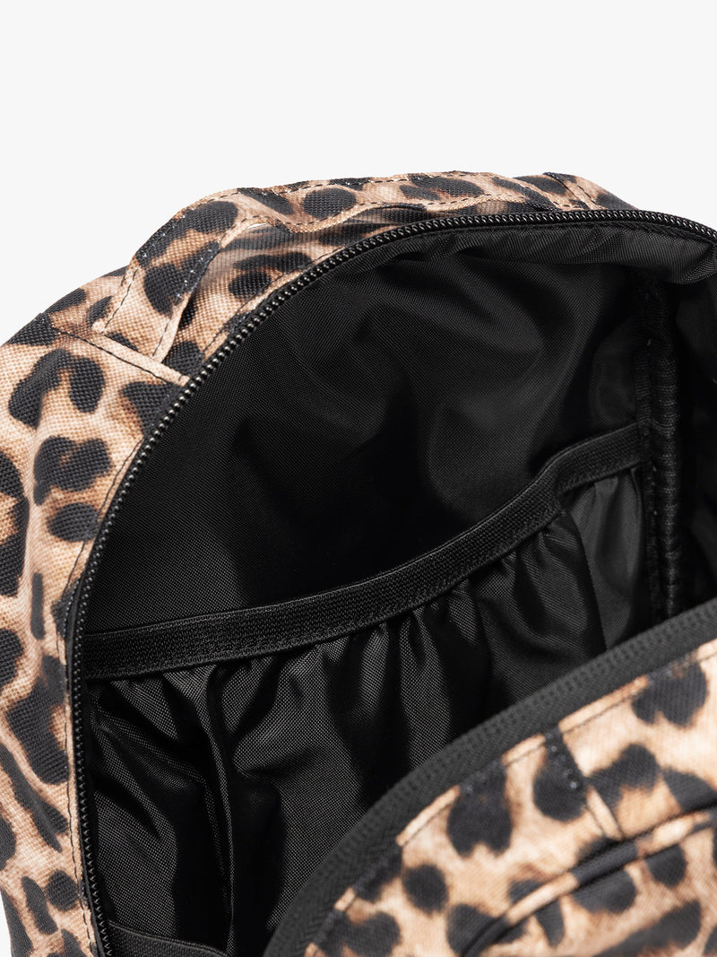 Close up of the compartments inside the Leopard print in Leopard the CALPAK Everything Cube organizer with a top handle, a front zippered pocket, and a textured mesh lower panel, shown against a plain white background