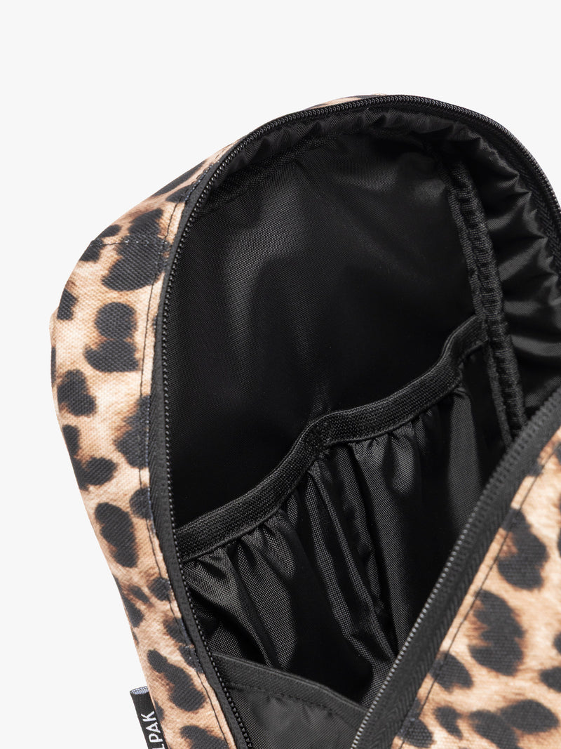 Close up of the compartments inside the Leopard print in Leopard the CALPAK Everything Cube organizer with a top handle, a front zippered pocket, and a textured mesh lower panel, shown against a plain white background