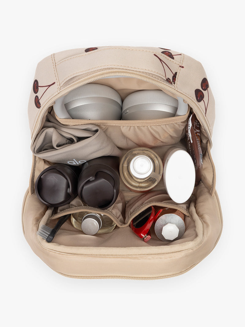 Opened view with items inside CALPAK Everything Cube beige with cherry print Oatmeal Pink