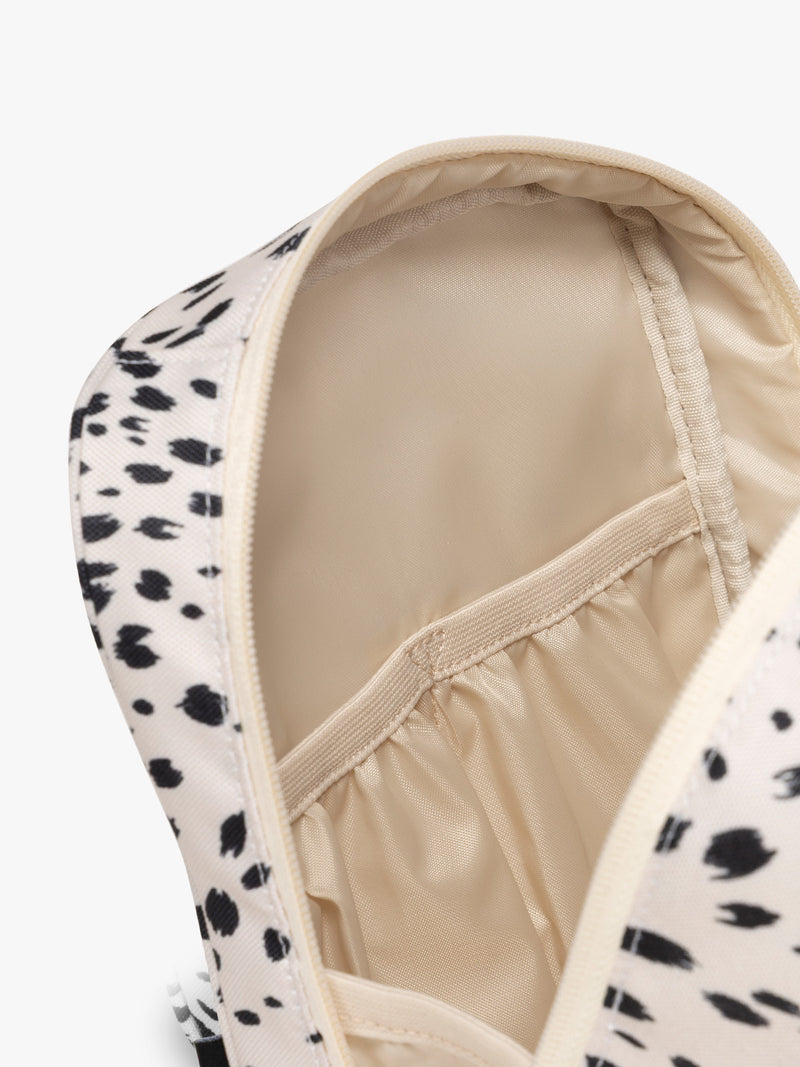Closer up of compartment of White with black leopard print in Snow Leopard the CALPAK Everything Cube organizer with a top handle, a front zippered pocket, and a textured mesh lower panel, shown against a plain white background
