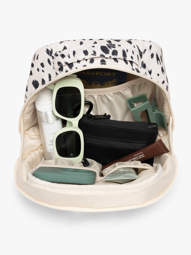 Inside the white with black leopard print in Snow Leopard the CALPAK Everything Cube organizer with a top handle, a front zippered pocket, and a textured mesh lower panel, shown against a plain white background