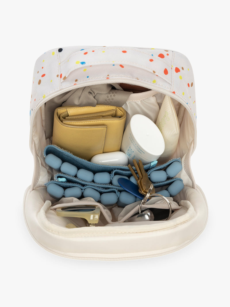 Items inside CALPAK Everything Cube in beige with speckle pattern