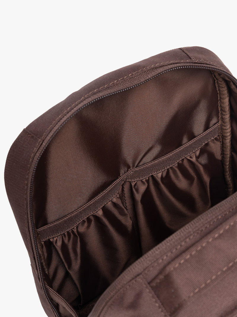 Inside pockets of CALPAK Everything Cube in brown Walnut