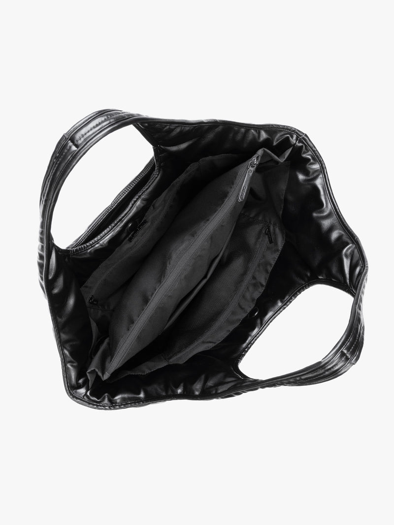 Top view showing inside of Black quilted puffer CALPAK Luka Everything Tote Bag with a smooth finish and double shoulder straps, shown against a plain white background