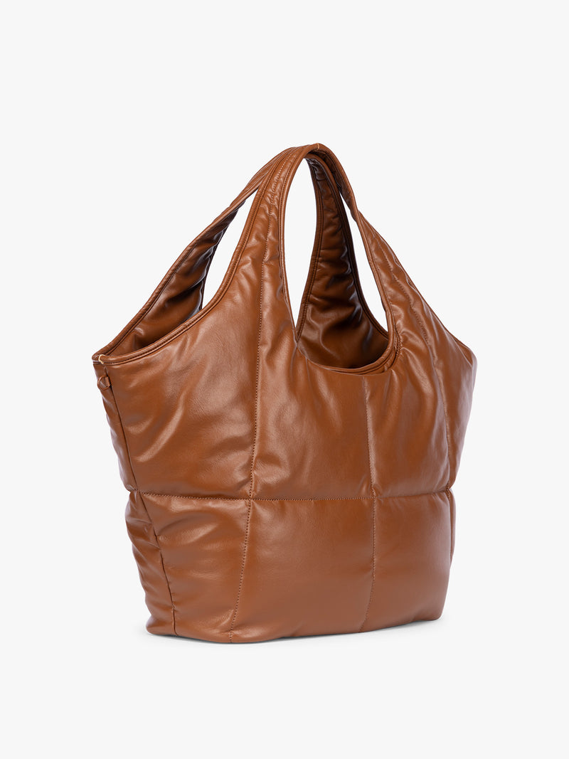 Side view of Honey Brown quilted puffer CALPAK Luka Everything Tote Bag with a smooth finish and double shoulder straps, shown against a plain white background