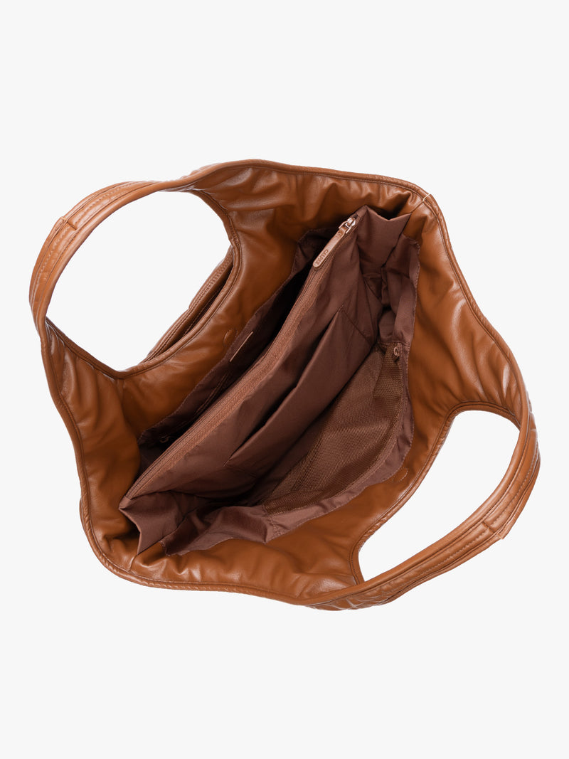 Top view showing inside of Honey Brown quilted puffer CALPAK Luka Everything Tote Bag with a smooth finish and double shoulder straps, shown against a plain white background