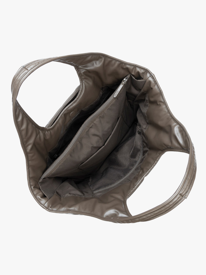 Top view showing inside of the Mushroom brown quilted puffer CALPAK Luka Everything Tote Bag with a smooth finish and double shoulder straps, shown against a plain white background