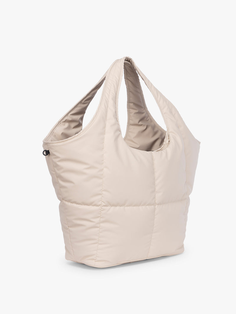 Side view of CALPAK Luka Everything Tote in off-white beige Oatmeal