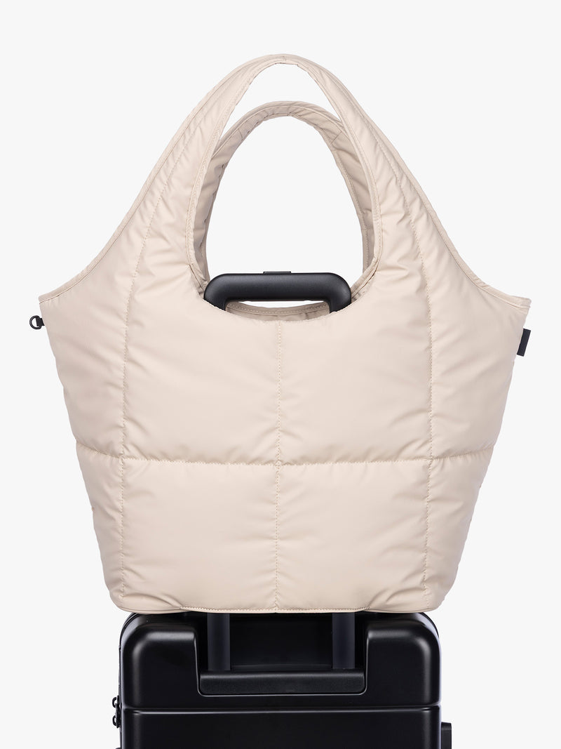 Luggage trolley sleeve of CALPAK Luka Everything Tote in off-white beige Oatmeal