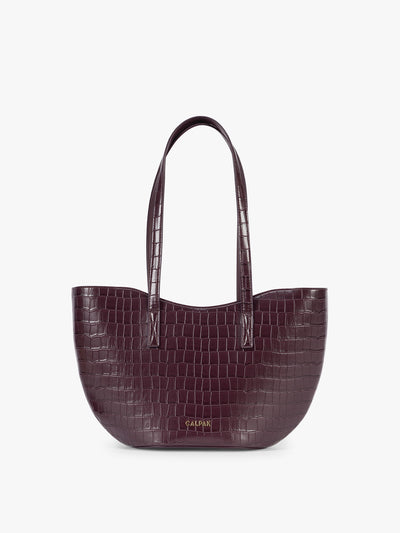 A CALPAK Haven Tulip Tote in Dark Cherry dark plum purple crocodile-embossed leather tote bag with double shoulder straps  against a plain white background ; AHP2601-DARK-CHERRY-FAUX-CROC view 1