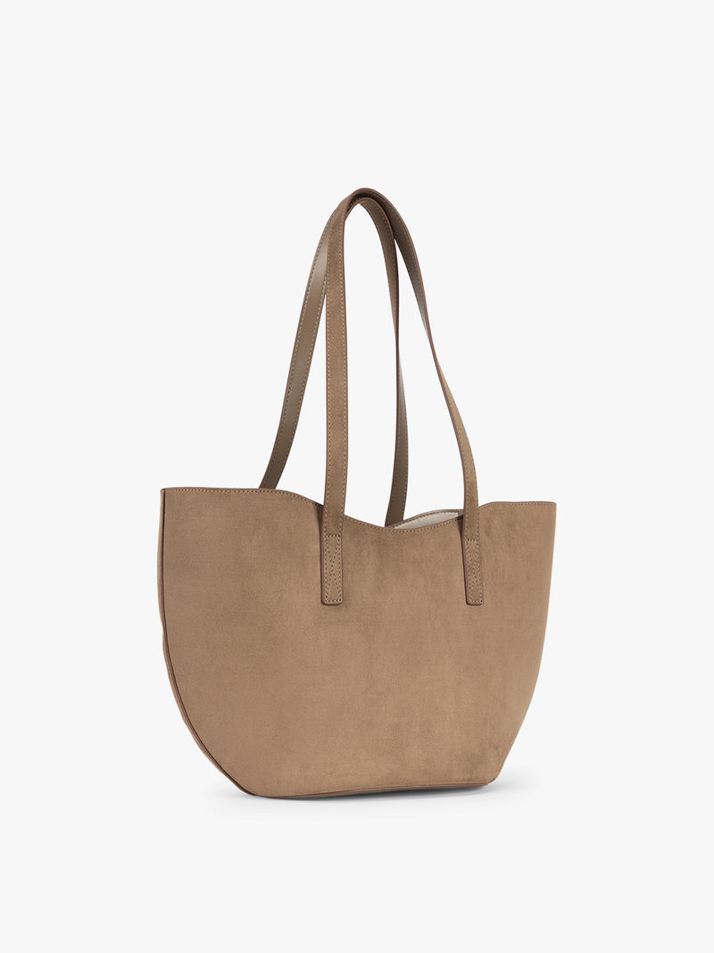 Side view of CALPAK Haven Tulip Tote in Truffle Suede taupe brown tote bag with dual shoulder straps against a plain white background