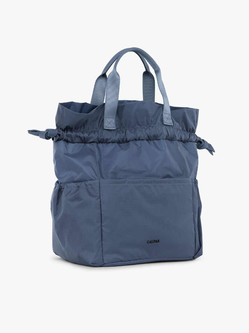 CALPAK Insulated Lunch Bag in blue Indigo side view open with handles